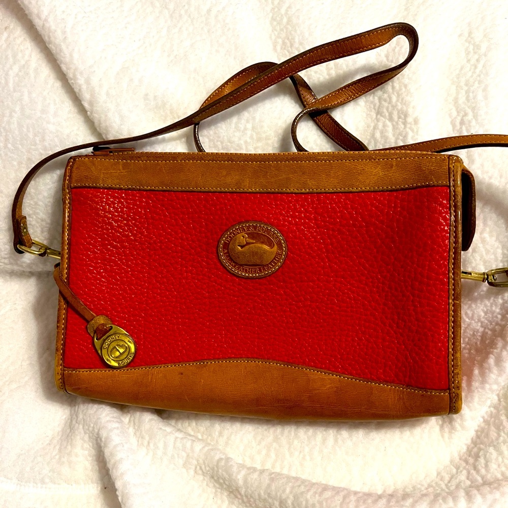 Dooney red vintage with tan leather strap and bottom